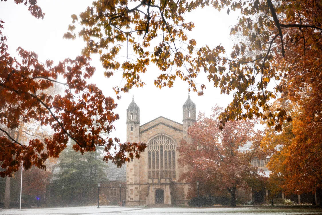 The Law Quad on a misty fall day with the leaves on the trees turning yellow, red, and orange.
